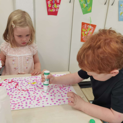 The children enjoying paint dots together.