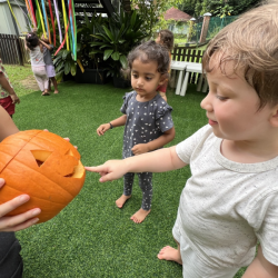 Alex curious with a jack-o-lantern