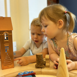 Rosie & Edwina engrossed in Christmas village small world play