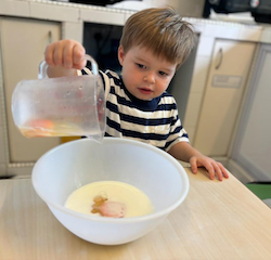 Johnny tipping the egg into the mixture!